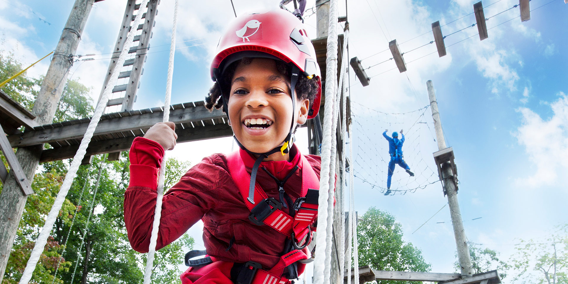 little boy smiling on low ropes course