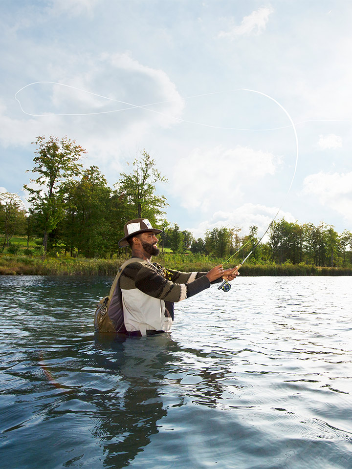 man fishing standing in water