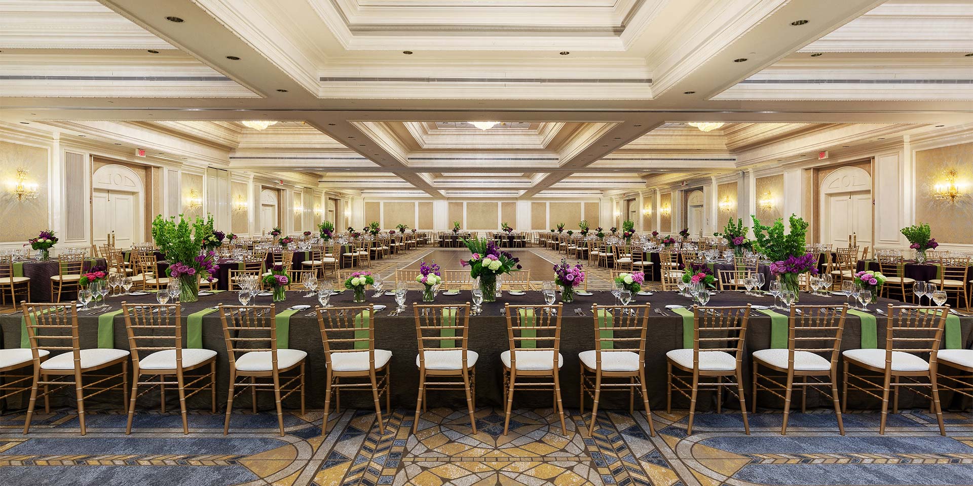 large square room with table and chairs surrounding the perimeter