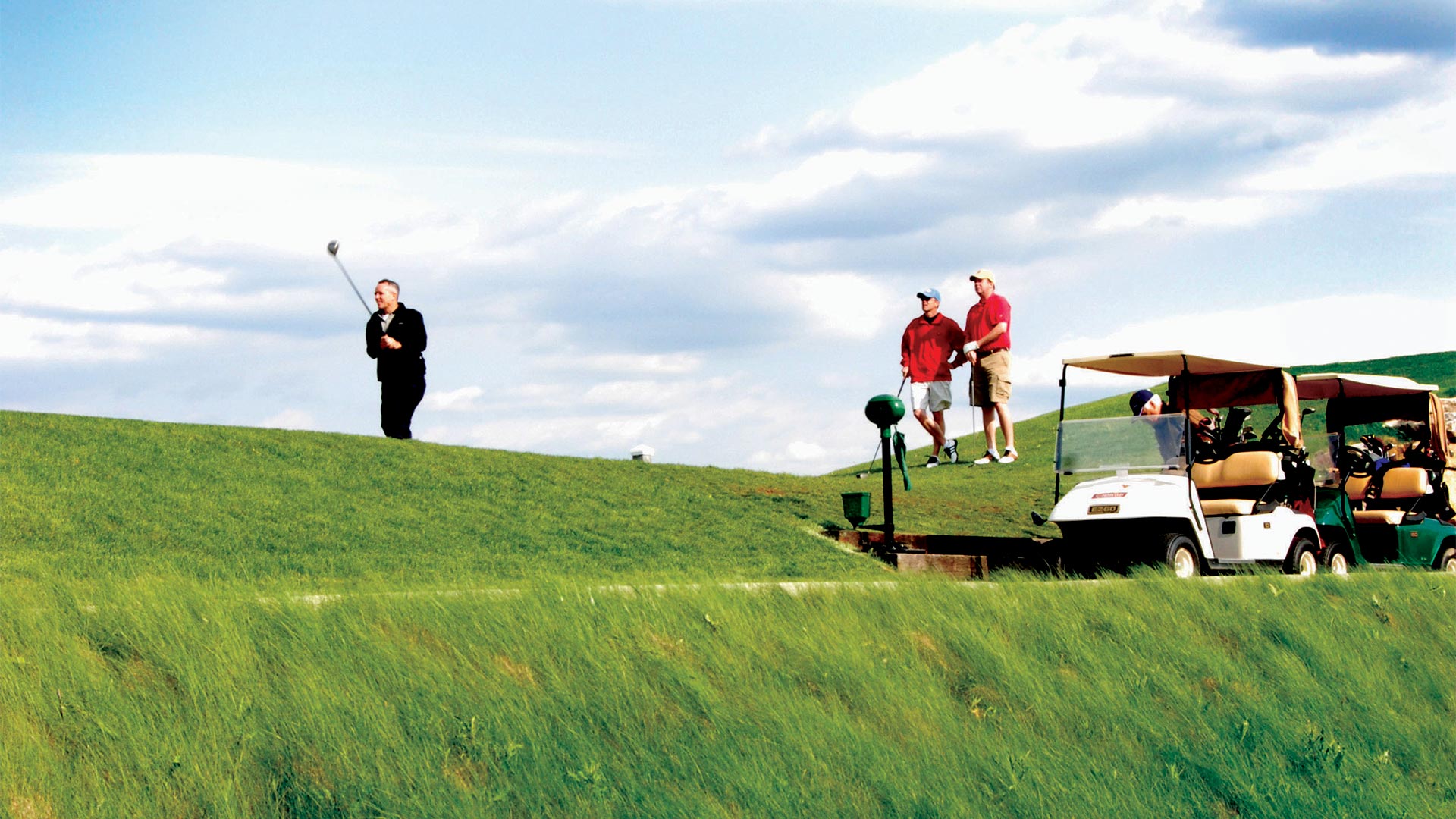 three men golfing