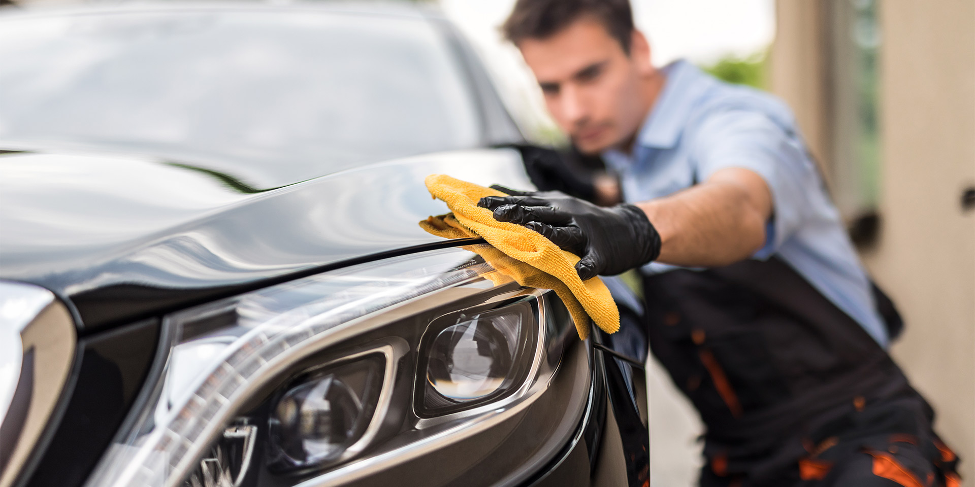 man washing car