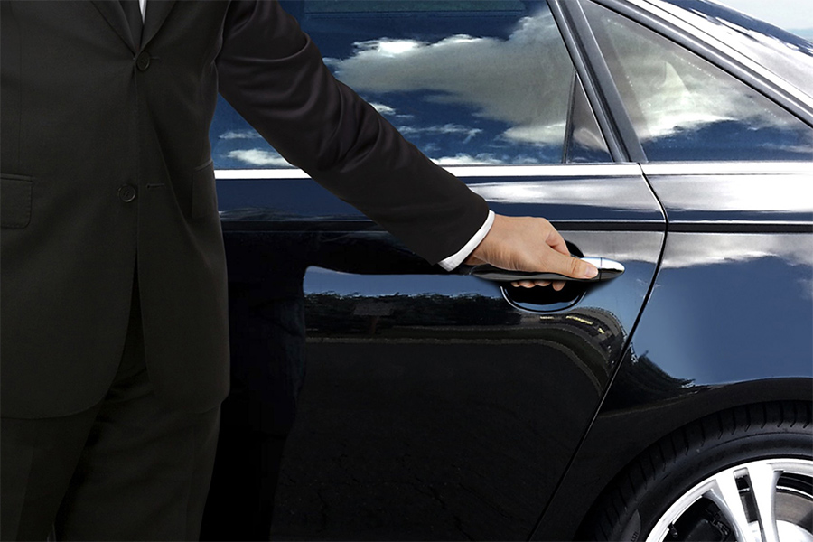 man with hand on car door handle