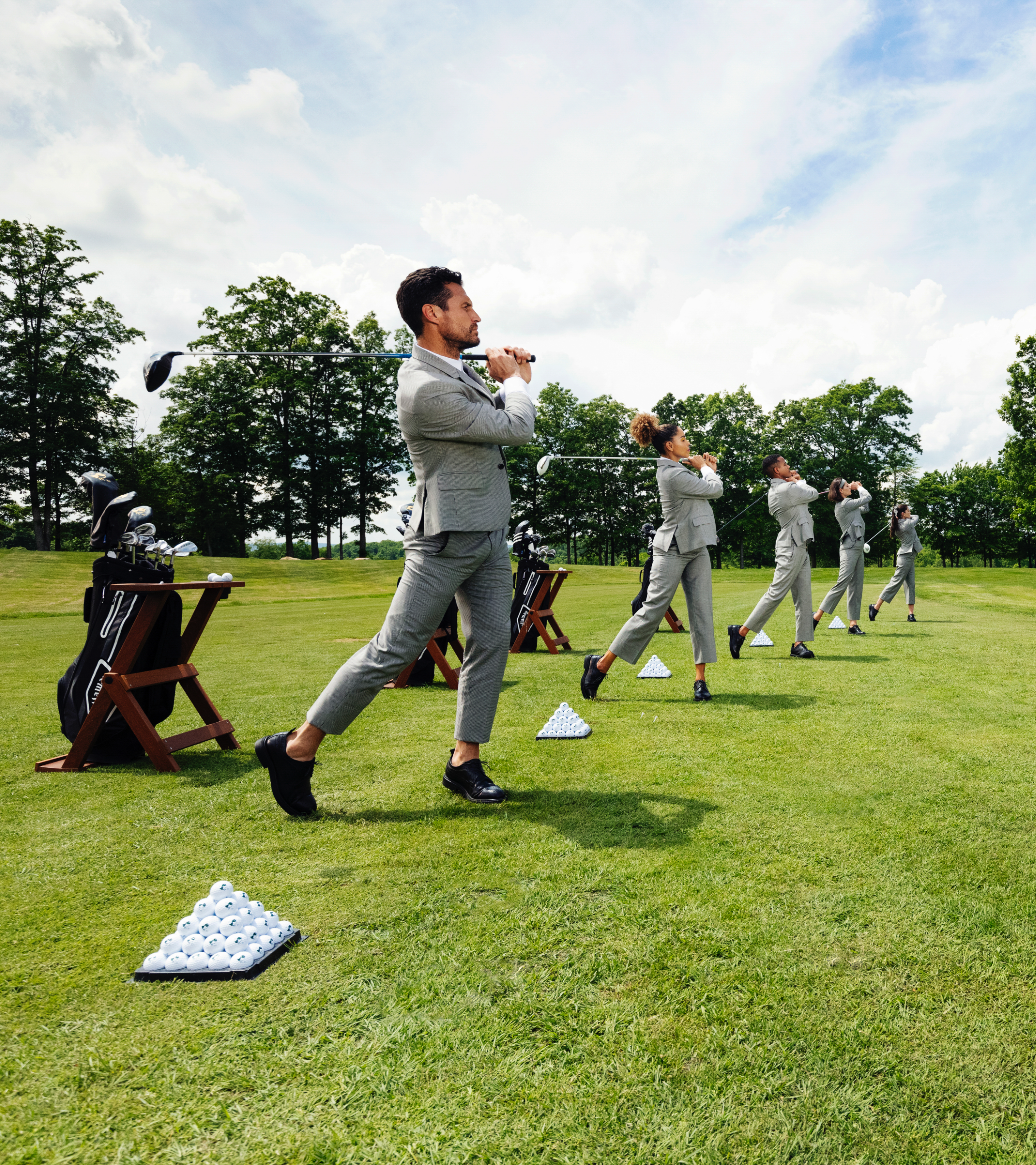 Group golfing in suits outdoors