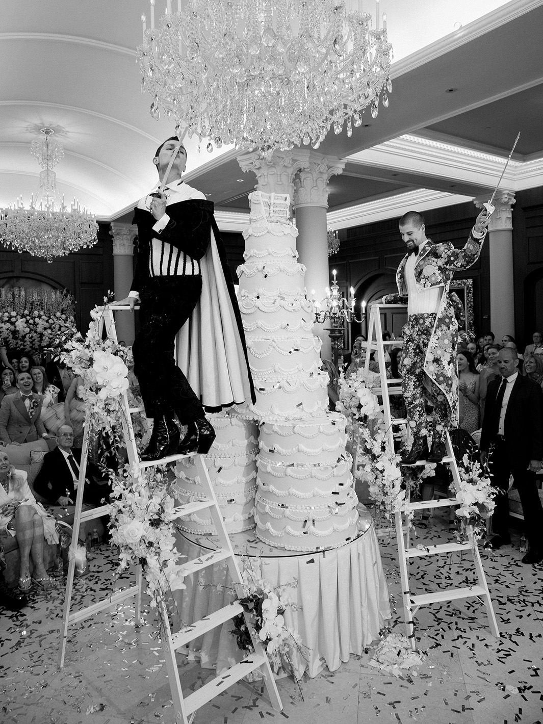 cutting the giant wedding cake in The Chateau Lobby