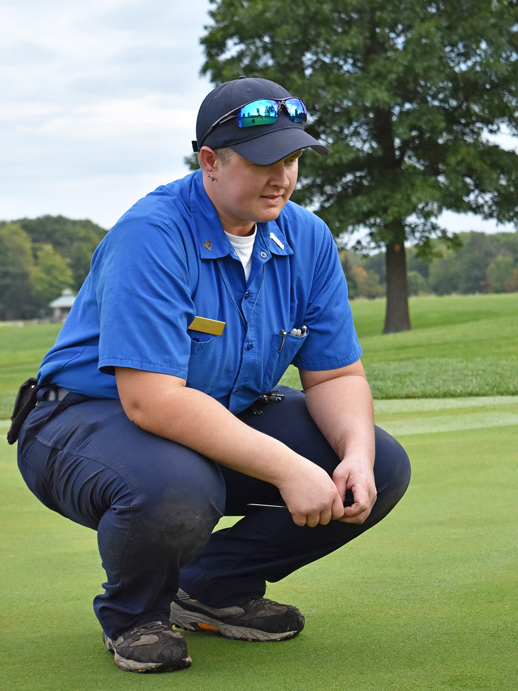 Turf grass worker checking the fairway