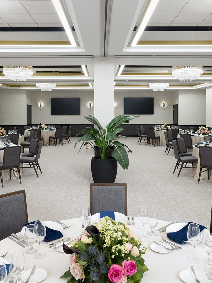 Round meeting tables in large conference room