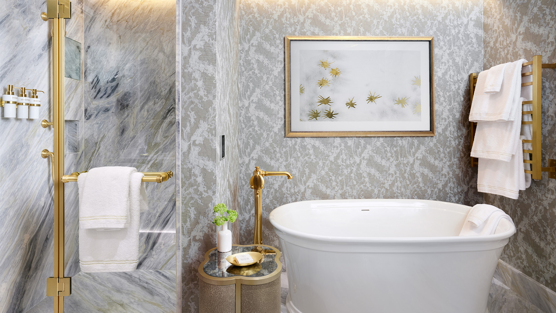 white soaking tub and a glass shower enclosure in a suite at The Grand Lodge at Nemacolin