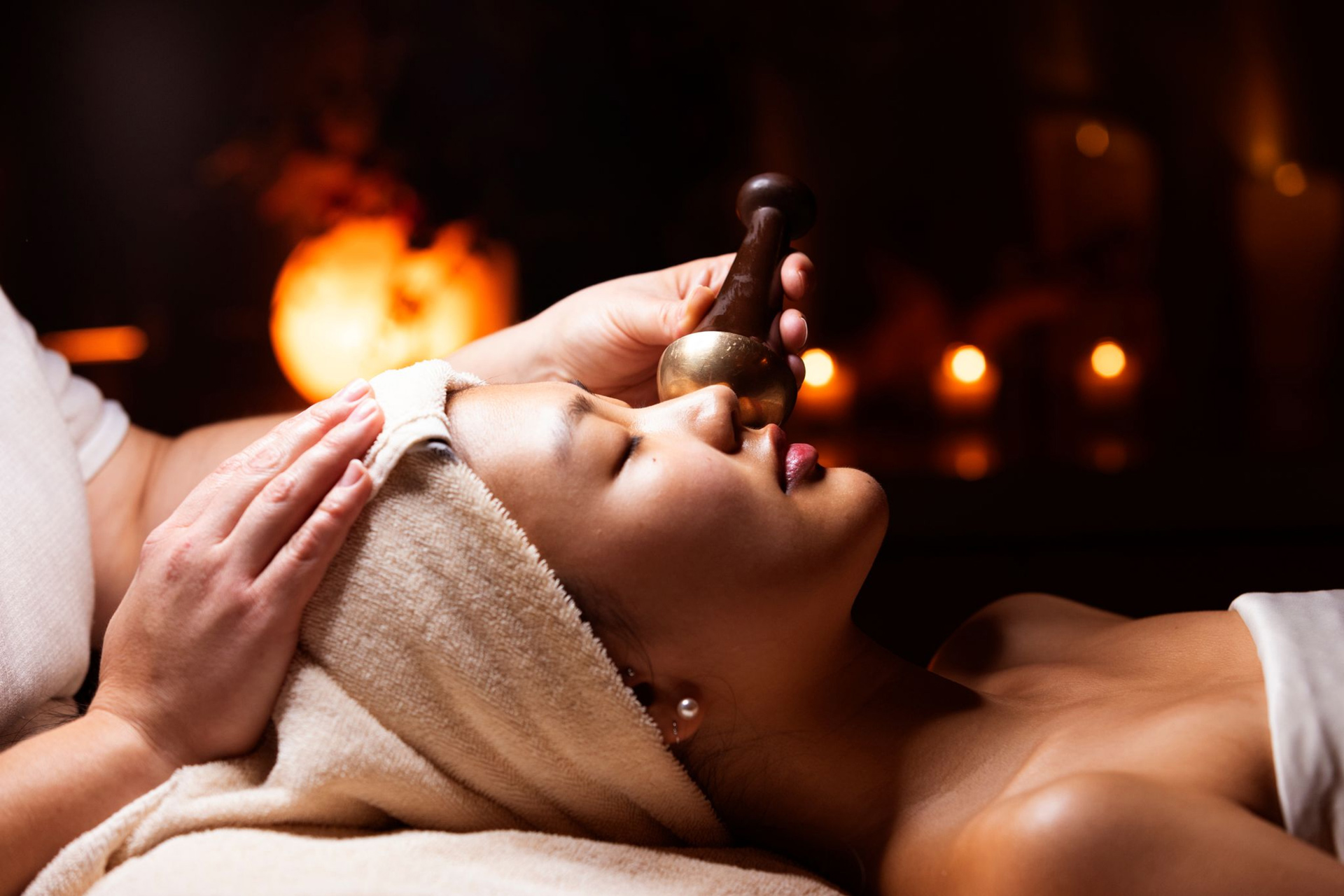 Click here to open the gallery overlay for the image: woman laying down on a spa table getting a facial - as part of a gallery decorative page