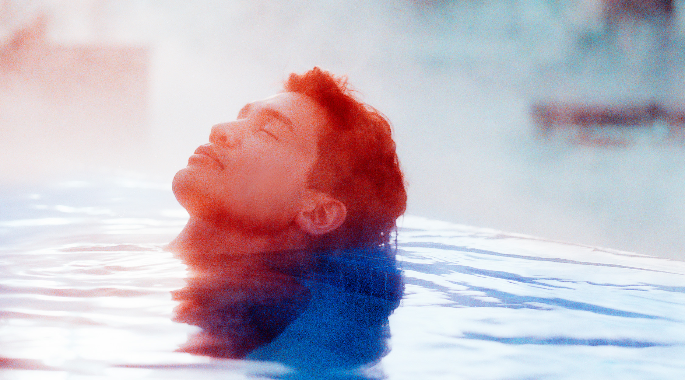 A man relaxing in a hot tub at The Peak at Nemacolin